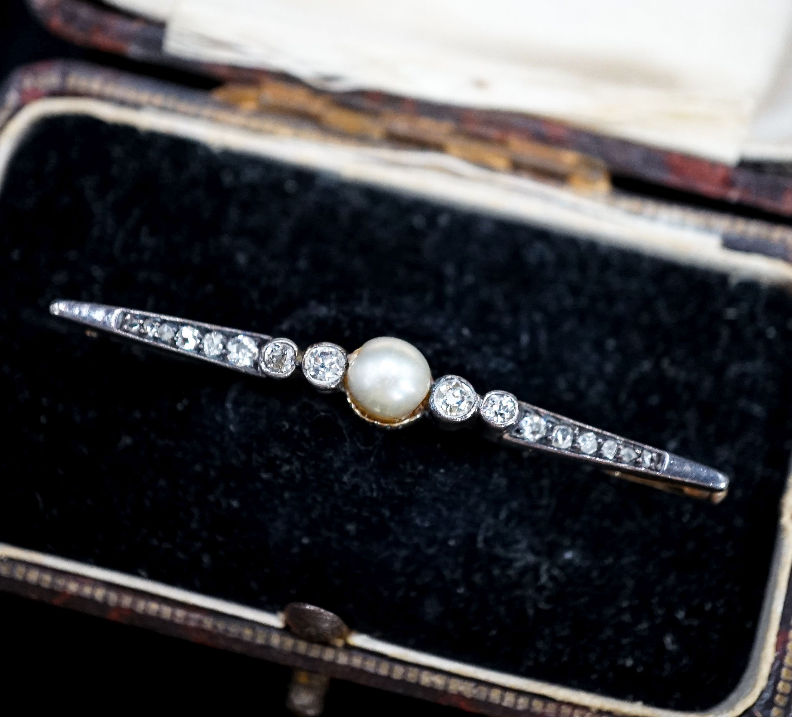 An early 20th century pearl and diamond set bar brooch, 50mm, gross 3.8 grams.